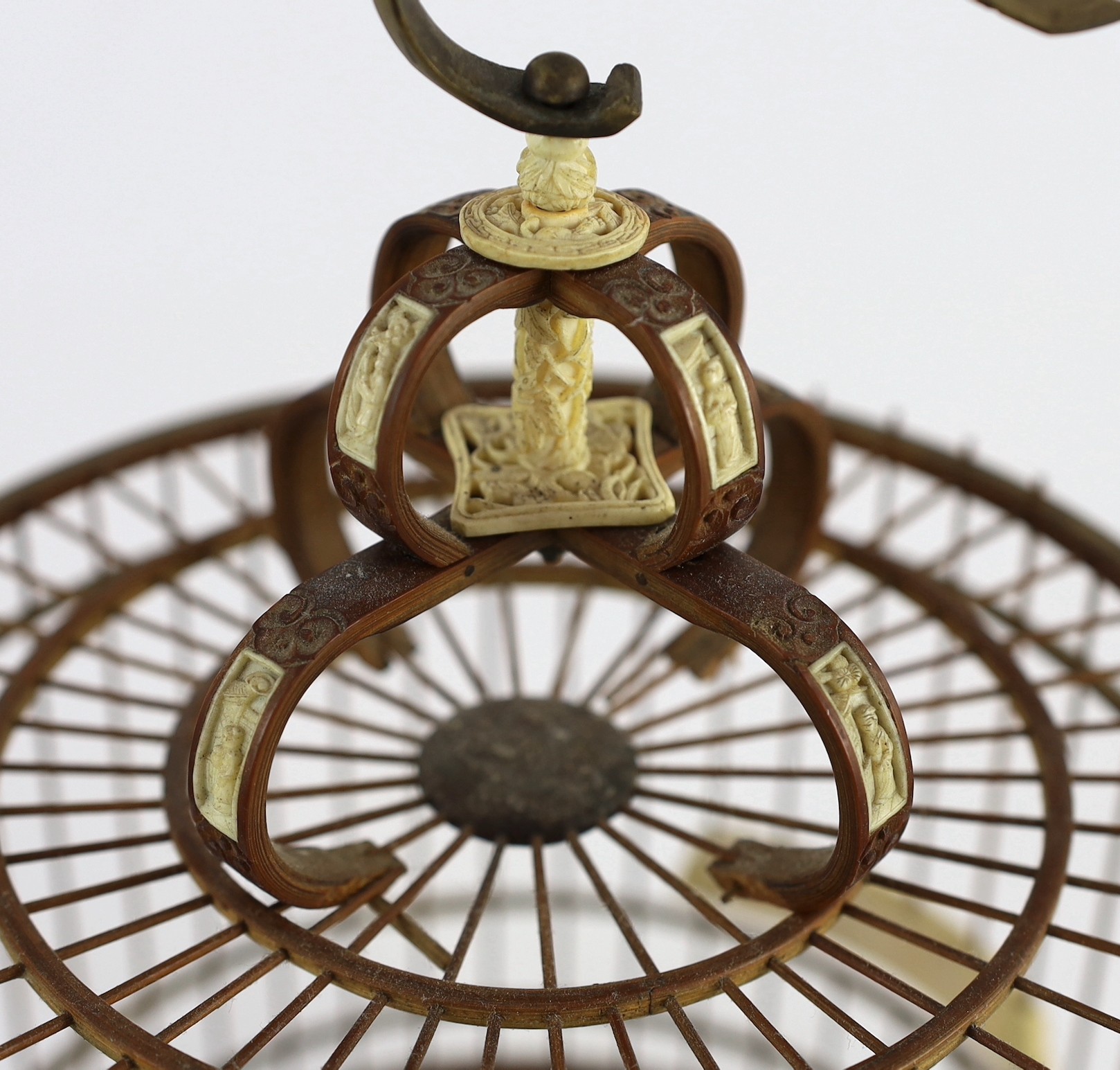 A Chinese bamboo and Guangzhou ivory mounted bird cage, late Qing dynasty, with two Guangxu mark and period porcelain bird feeders (1875-1908), cage 32.5cm high to top of handle